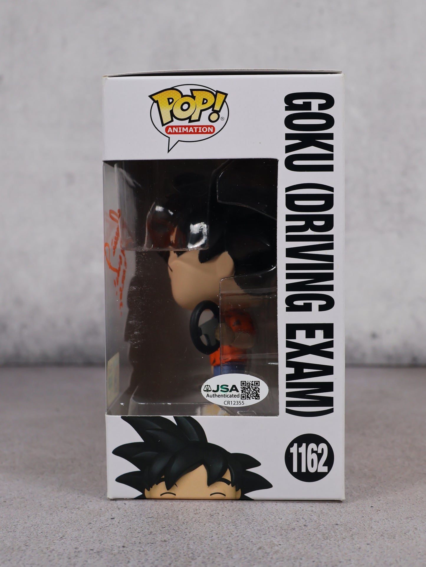 Funko Pop SDCC 2022 Goku driving exam firmado por Mario Castañeda